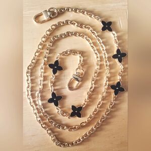 Crossbody Chain With Black Floral Accents.
